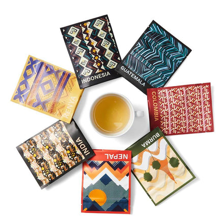 Assortment of teas offered by the club next to a white cup