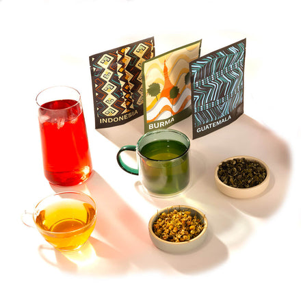 A line up of teas and mugs on a white table